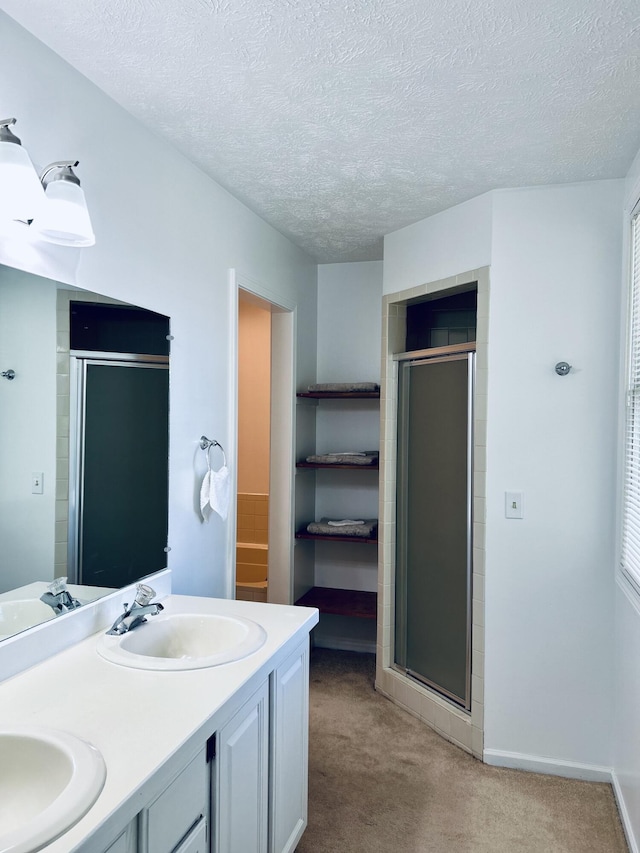 5335 Heathrow Ave, Kalamazoo, MI 49009 - full bathroom with a stall shower, double vanity, a textured ceiling, and a closet