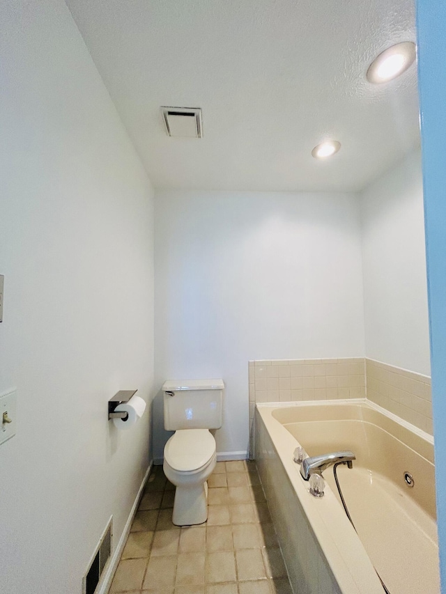 5335 Heathrow Ave, Kalamazoo, MI 49009 - full bath with toilet, a garden tub, tile patterned floors, and baseboards