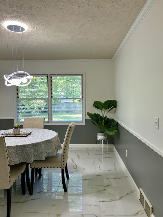 5335 Heathrow Ave, Kalamazoo, MI 49009 - dining space with a textured ceiling, a chandelier, plenty of natural light, marble finish floors, and crown molding