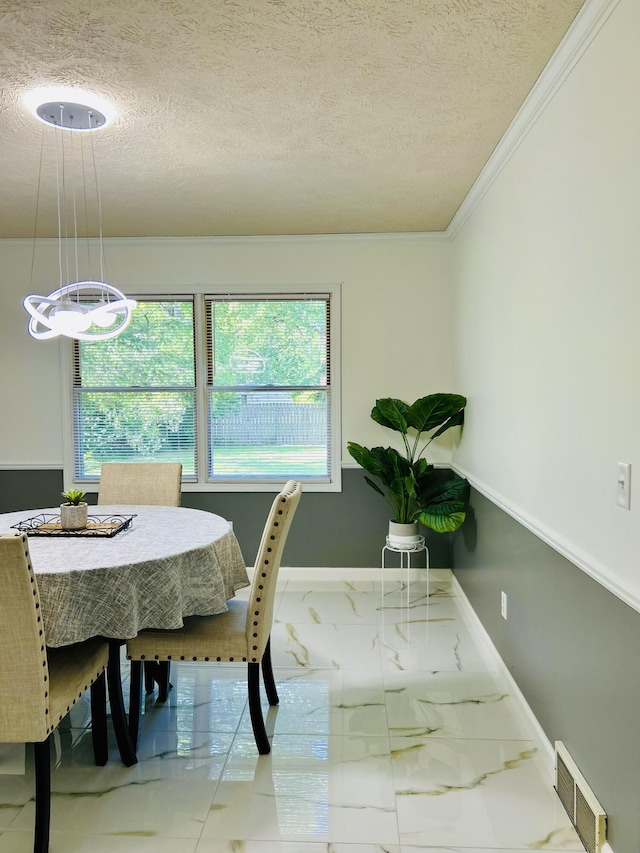 5335 Heathrow Ave, Kalamazoo, MI 49009 - dining space featuring a textured ceiling, marble look tile flooring, crown molding, baseboards, and a chandelier