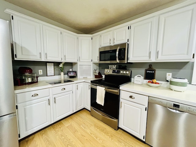 5335 Heathrow Ave, Kalamazoo, MI 49009 - kitchen with appliances with stainless steel finishes, white cabinetry, and light wood-type flooring