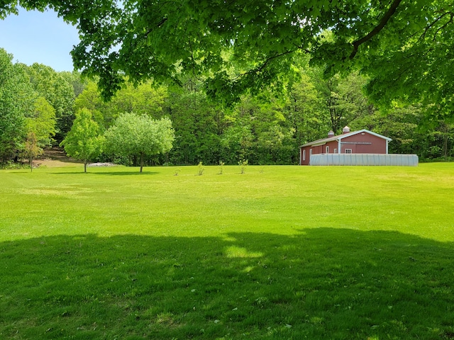 9490 N 12th St, Kalamazoo, MI 49009 - view of grassy yard featuring a pole building, an outdoor structure, and a view of trees