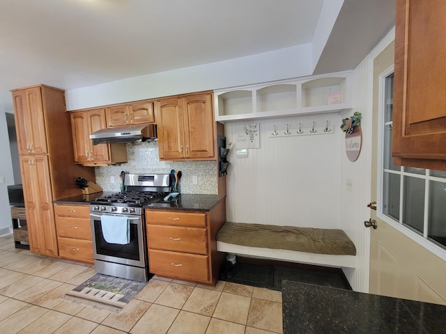 9490 N 12th St, Kalamazoo, MI 49009 - kitchen with under cabinet range hood, stainless steel range with gas stovetop, backsplash, open shelves, and brown cabinetry