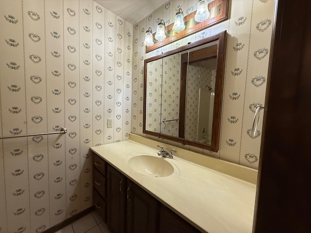 6035 W Trails End Rd, Ludington, MI 49431 - bathroom with vanity, tile patterned flooring, and wallpapered walls