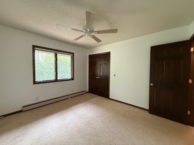 6035 W Trails End Rd, Ludington, MI 49431 - unfurnished bedroom with a baseboard radiator, light colored carpet, a closet, a textured ceiling, and baseboards