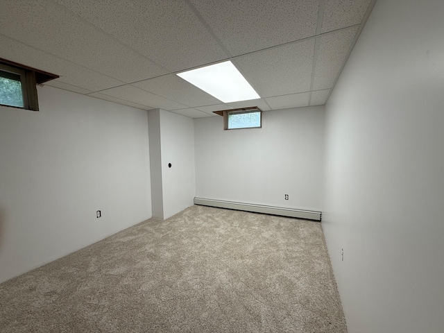 6035 W Trails End Rd, Ludington, MI 49431 - basement featuring baseboard heating, carpet flooring, and a drop ceiling