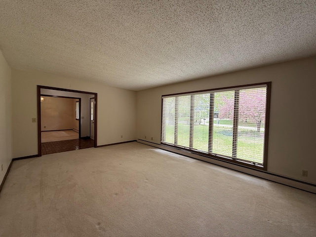 6035 W Trails End Rd, Ludington, MI 49431 - unfurnished room with light colored carpet, a textured ceiling, and baseboards
