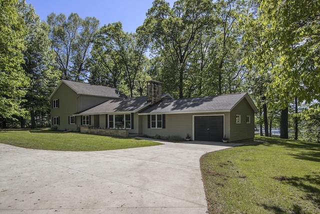 15842 Portage Rd, Vicksburg, MI 49097 - view of front of property featuring concrete driveway, a garage, a chimney, and a front lawn