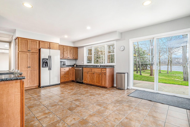 15842 Portage Rd, Vicksburg, MI 49097 - kitchen with refrigerator with ice dispenser, dishwasher, recessed lighting, a sink, and brown cabinets