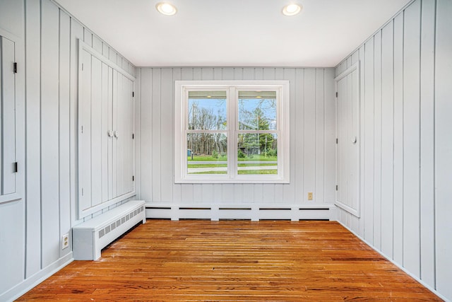 15842 Portage Rd, Vicksburg, MI 49097 - spare room featuring wood finished floors, recessed lighting, and radiator