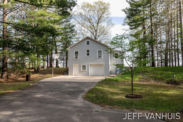 6789 W 76th St, Baldwin, MI 49304 - view of side of home with driveway and an attached garage