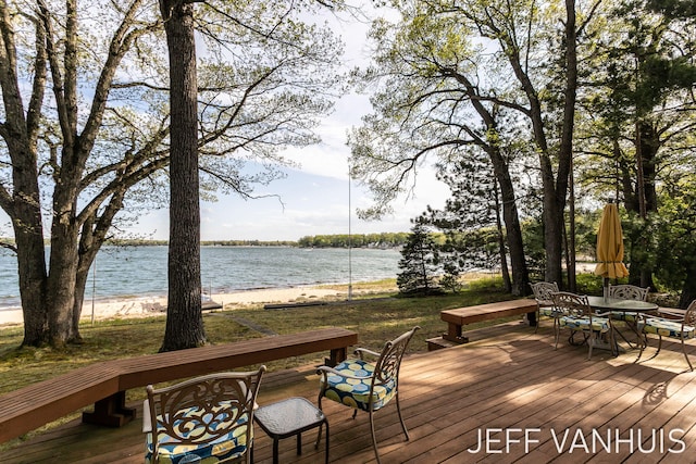 6789 W 76th St, Baldwin, MI 49304 - wooden deck with a water view and outdoor dining area