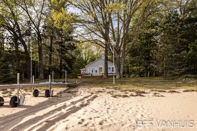 6789 W 76th St, Baldwin, MI 49304 - view of yard with a wooden deck and a forest view