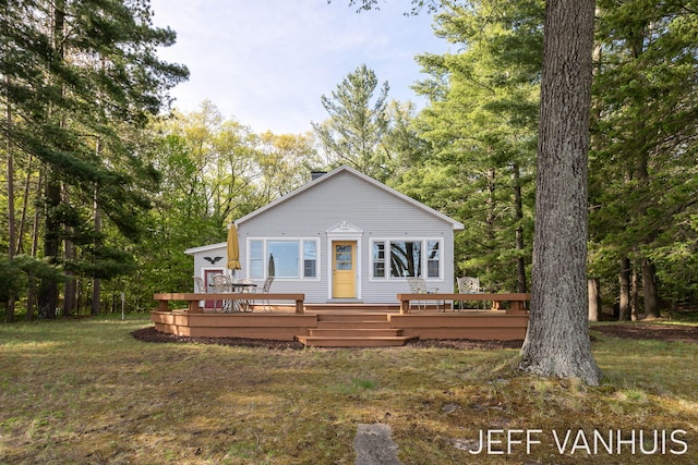 6789 W 76th St, Baldwin, MI 49304 - view of front of home with a deck and a front yard