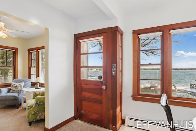 6789 W 76th St, Baldwin, MI 49304 - foyer entrance with baseboard heating, light carpet, plenty of natural light, and a water view