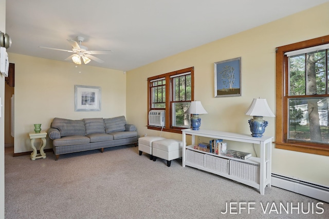 6789 W 76th St, Baldwin, MI 49304 - carpeted living area featuring plenty of natural light, a ceiling fan, a baseboard radiator, and baseboards