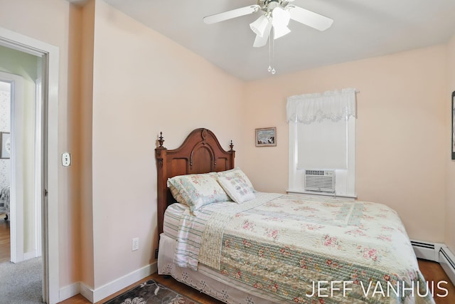 6789 W 76th St, Baldwin, MI 49304 - bedroom with baseboard heating, baseboards, and ceiling fan