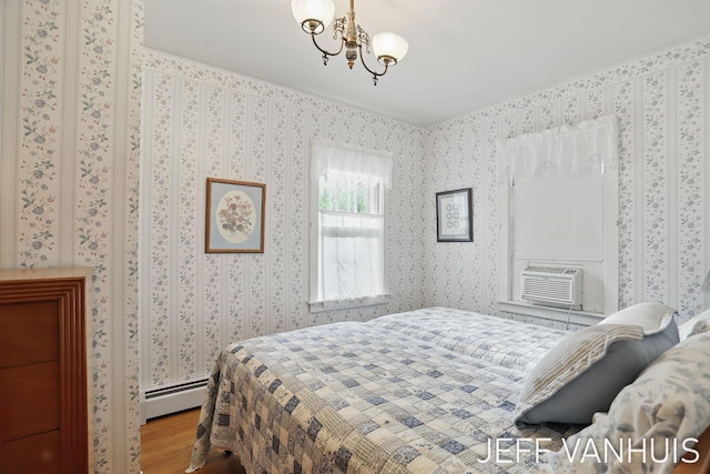 6789 W 76th St, Baldwin, MI 49304 - bedroom featuring wood finished floors, a chandelier, a baseboard heating unit, and cooling unit