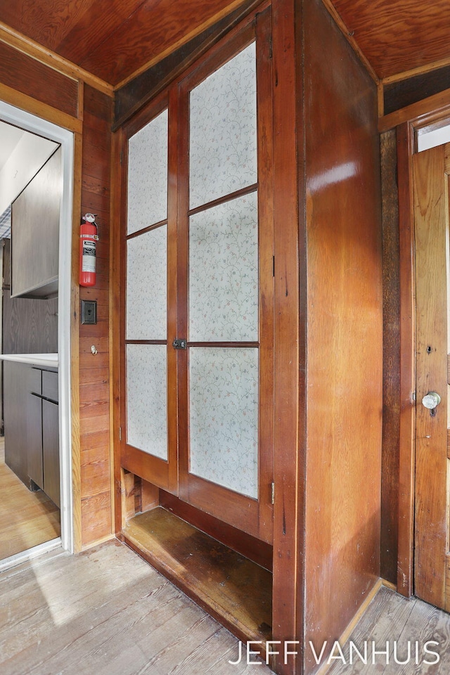 6789 W 76th St, Baldwin, MI 49304 - detailed view of wood finished floors, a fire extinguisher, wooden ceiling, and wood walls