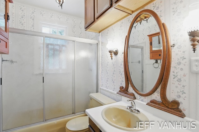 6789 W 76th St, Baldwin, MI 49304 - full bathroom with wallpapered walls, toilet, vanity, and combined bath / shower with glass door