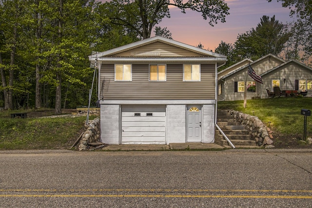 5729 N Bass Lake Rd, Irons, MI 49644 - view of front of home with an attached garage and driveway