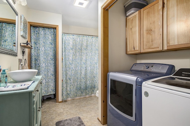 5729 N Bass Lake Rd, Irons, MI 49644 - laundry room featuring washing machine and clothes dryer and cabinet space