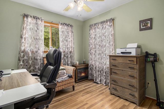 5729 N Bass Lake Rd, Irons, MI 49644 - home office featuring a ceiling fan and light wood-style flooring