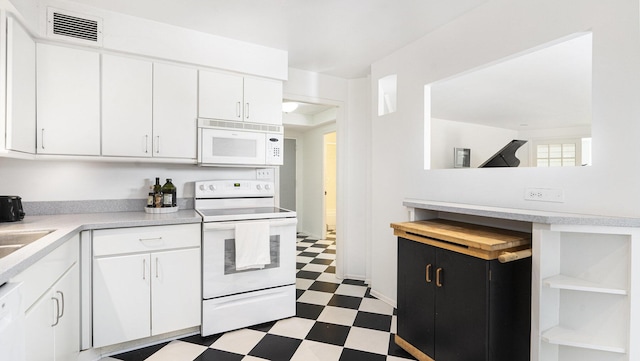 1050 Wall St Unit 2C, Ann Arbor, MI 48105 - kitchen featuring white appliances, tile patterned floors, light countertops, white cabinets, and open shelves