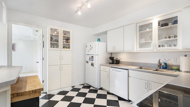 1050 Wall St Unit 2C, Ann Arbor, MI 48105 - kitchen with white appliances, tile patterned floors, a sink, white cabinetry, and light countertops
