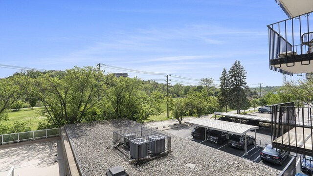 1050 Wall St Unit 2C, Ann Arbor, MI 48105 - view of yard with central AC unit, view of wooded area, and stairway