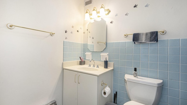 1050 Wall St Unit 2C, Ann Arbor, MI 48105 - bathroom with tile walls, vanity, and toilet
