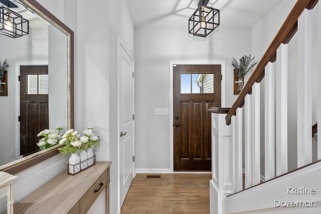 12036 Harvest Home Dr, Lowell, MI 49331 - entrance foyer with light wood finished floors, stairs, and baseboards