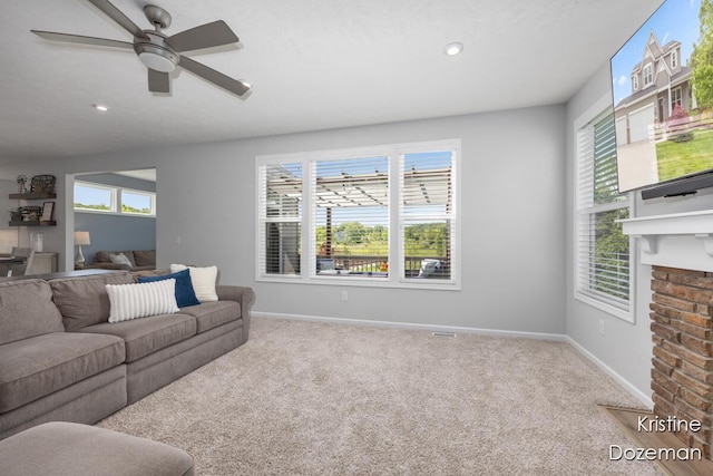 12036 Harvest Home Dr, Lowell, MI 49331 - living area featuring carpet floors, baseboards, recessed lighting, a ceiling fan, and a fireplace with flush hearth