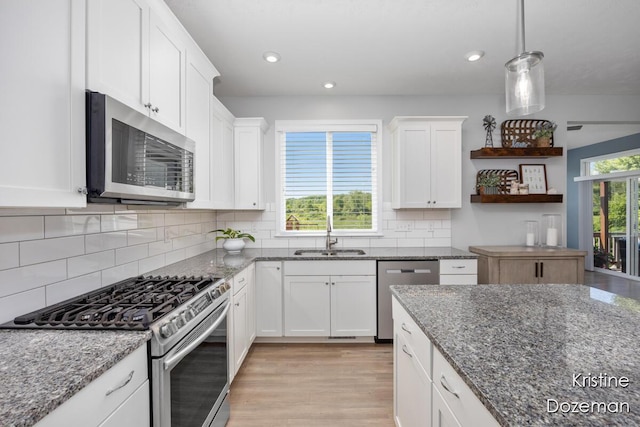 12036 Harvest Home Dr, Lowell, MI 49331 - kitchen with appliances with stainless steel finishes, a sink, open shelves, light wood-style floors, and white cabinetry