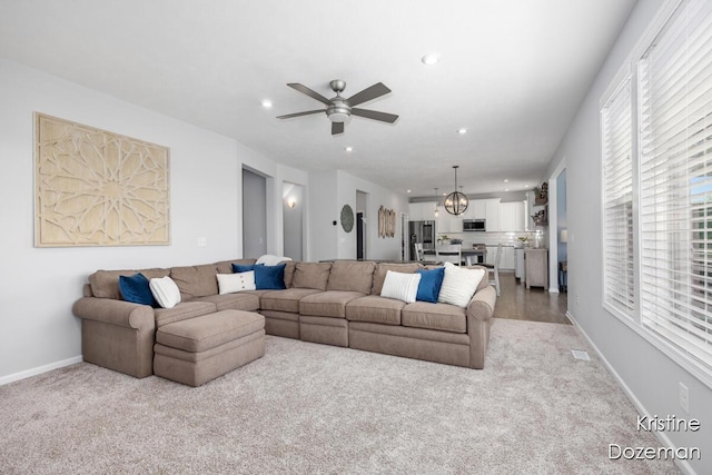 12036 Harvest Home Dr, Lowell, MI 49331 - living room with light colored carpet, a ceiling fan, baseboards, and recessed lighting