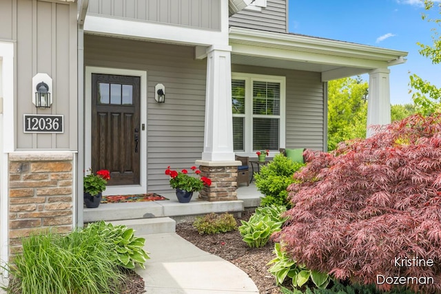 12036 Harvest Home Dr, Lowell, MI 49331 - doorway to property featuring a porch and board and batten siding