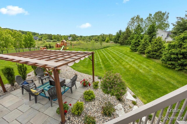 12036 Harvest Home Dr, Lowell, MI 49331 - view of green lawn featuring a patio and a playground
