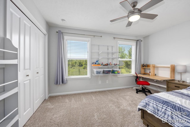 12036 Harvest Home Dr, Lowell, MI 49331 - carpeted bedroom featuring a closet, baseboards, and ceiling fan