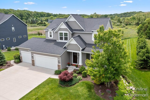 12036 Harvest Home Dr, Lowell, MI 49331 - craftsman inspired home featuring board and batten siding, an attached garage, driveway, a shingled roof, and a front lawn
