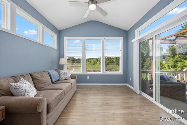 12036 Harvest Home Dr, Lowell, MI 49331 - living area featuring vaulted ceiling, ceiling fan, light wood-style flooring, and baseboards