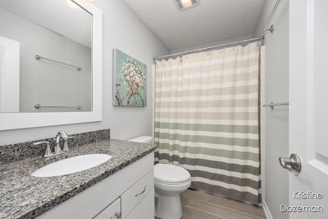 12036 Harvest Home Dr, Lowell, MI 49331 - full bathroom featuring vanity, wood finished floors, toilet, and curtained shower
