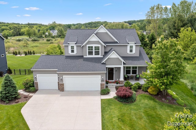 12036 Harvest Home Dr, Lowell, MI 49331 - craftsman house featuring roof with shingles, concrete driveway, stone siding, covered porch, and a garage