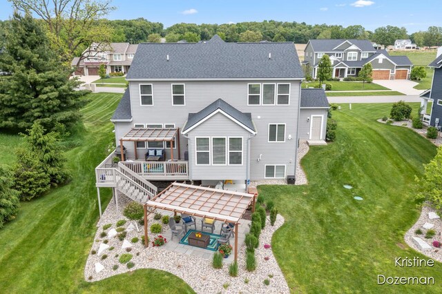 12036 Harvest Home Dr, Lowell, MI 49331 - rear view of house featuring a wooden deck, a patio, a pergola, a lawn, and a residential view