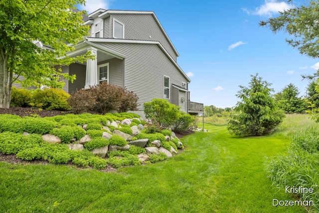 12036 Harvest Home Dr, Lowell, MI 49331 - view of side of home featuring a yard