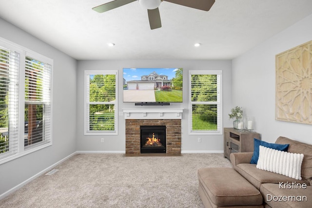 12036 Harvest Home Dr, Lowell, MI 49331 - carpeted living area with baseboards, a ceiling fan, and a fireplace