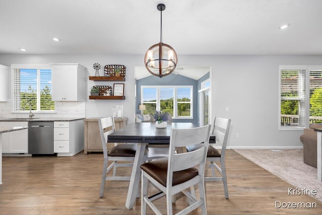 12036 Harvest Home Dr, Lowell, MI 49331 - dining space featuring light wood-style floors, recessed lighting, lofted ceiling, a chandelier, and baseboards