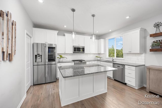 12036 Harvest Home Dr, Lowell, MI 49331 - kitchen featuring appliances with stainless steel finishes, a sink, white cabinetry, tasteful backsplash, and recessed lighting