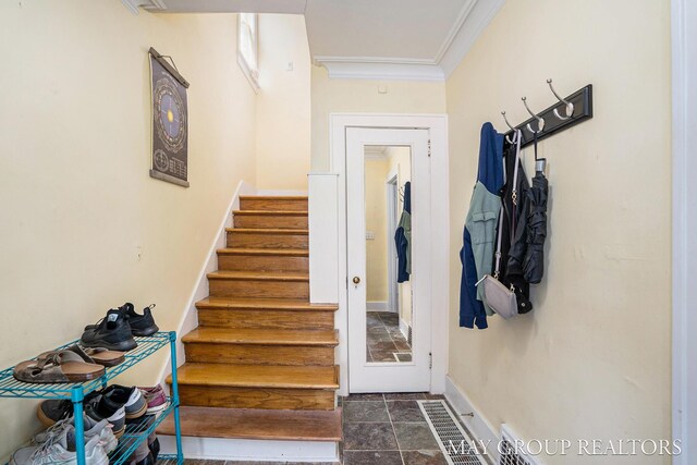 1212 Johnston St SE, Grand Rapids, MI 49507 - stairway with crown molding, stone finish floors, and baseboards