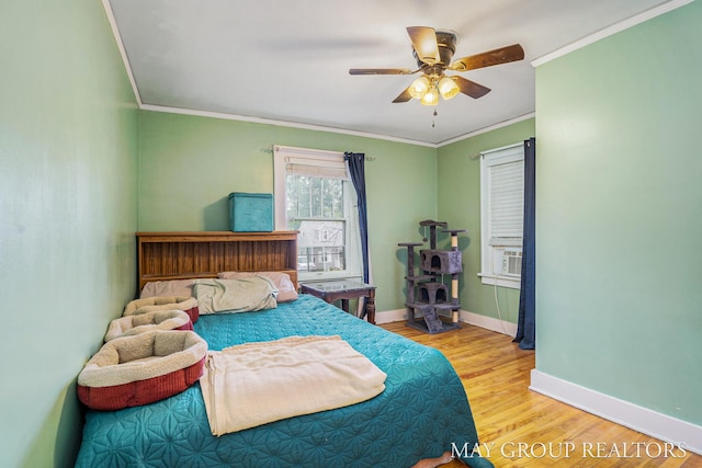 1212 Johnston St SE, Grand Rapids, MI 49507 - bedroom featuring crown molding, wood finished floors, baseboards, and a ceiling fan