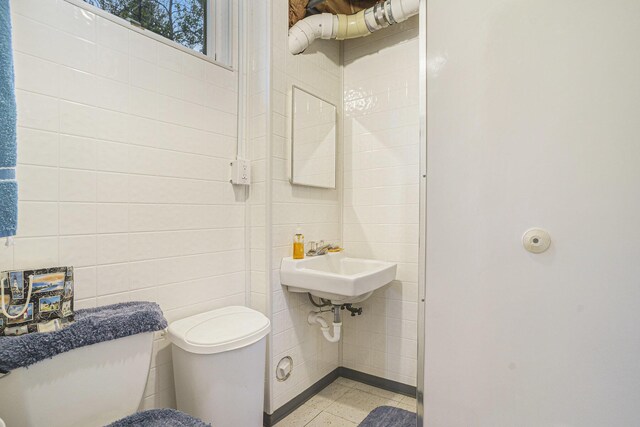 4900 N Railroad Ave, Pentwater, MI 49449 - half bathroom featuring toilet and tile walls